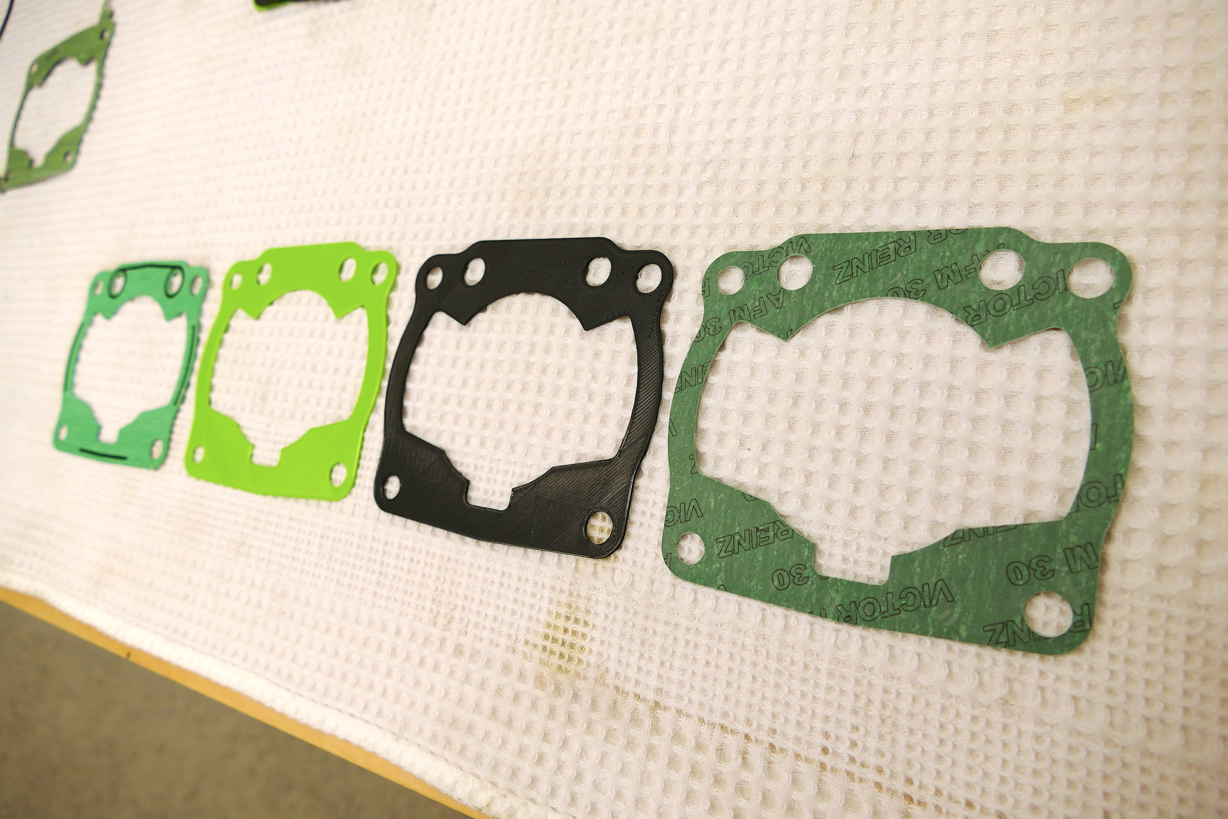 left to right: original Honda gasket, 1st prototype, 2nd prototype, production gasket